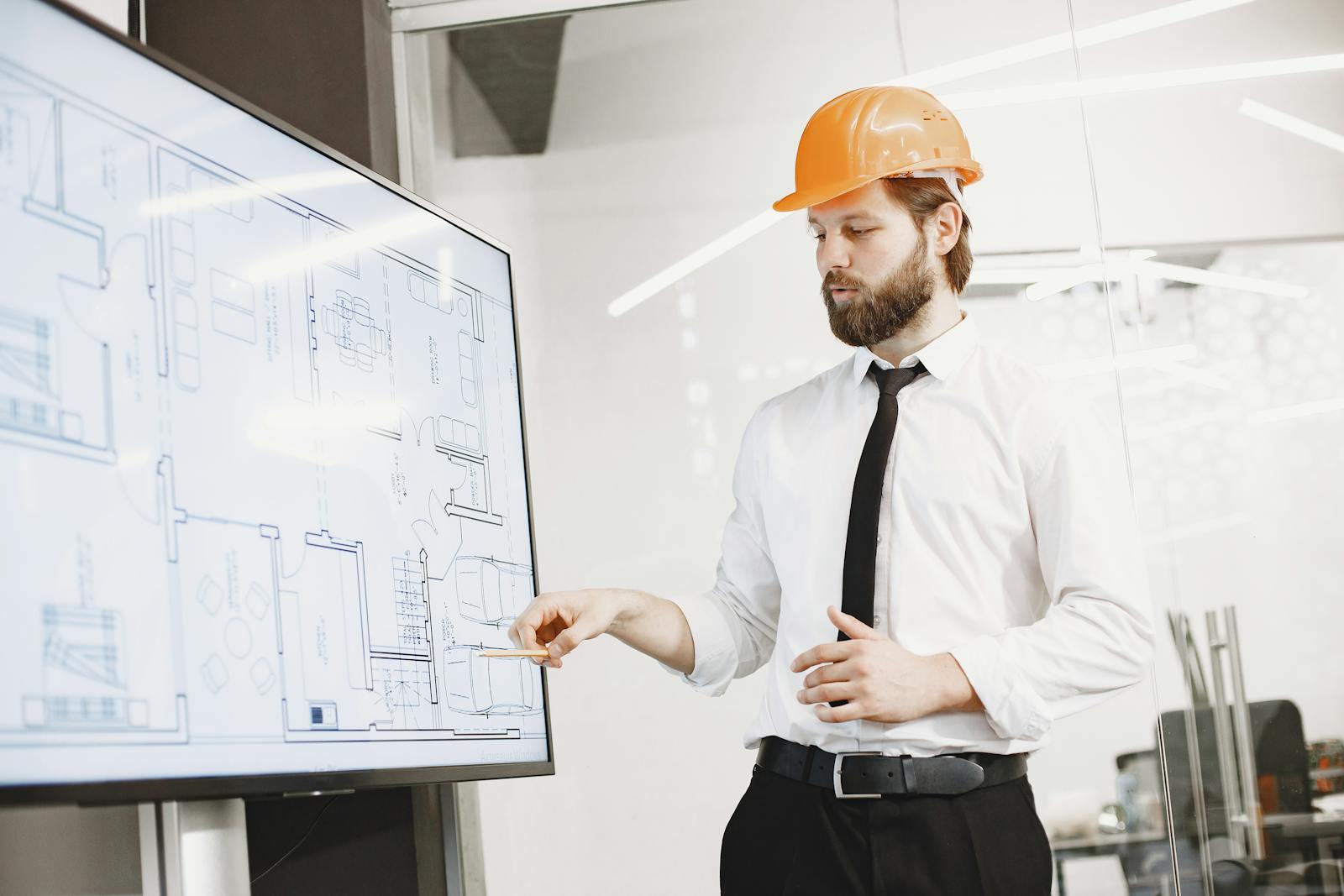Site engineer reviewing construction plans and blueprints